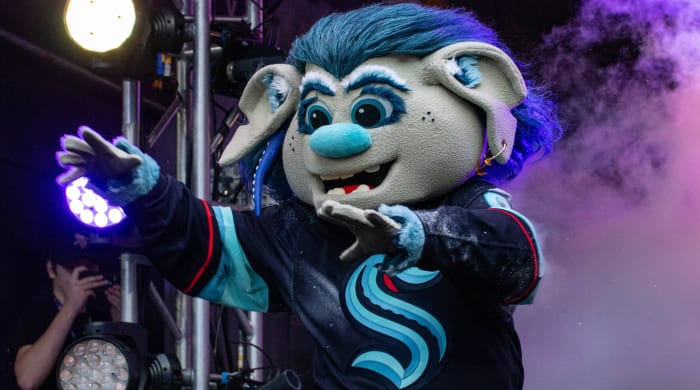 Seattle Kraken mascot Buoy exits the tunnel onto the field during an NFL game between the Indianapolis Colts and Minnesota Vikings.